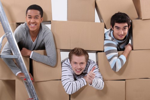 Local movers carrying household items from a flat in East London