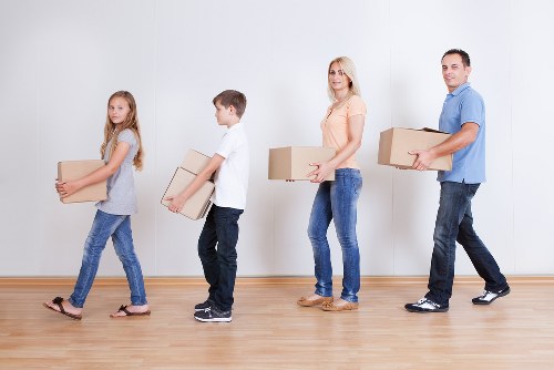 Professional movers loading household items for an East London relocation